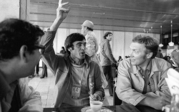 Легкоатлет Виктор Санеев (в центре) беседует с журналистами из ГДР в Олимпийской деревне во время проведения XXII Олимпийских игр в Москве - Sputnik Грузия