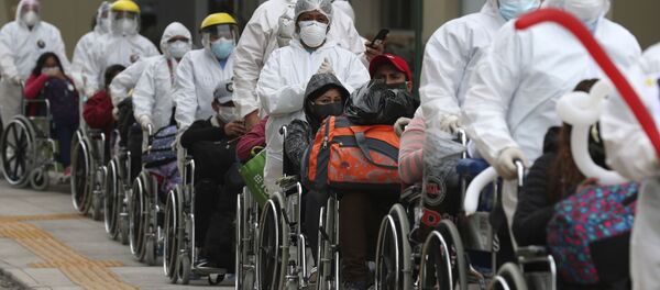 Пандемия коронавируса COVID-19. Медицинские работники вывозят группу из 80 пациентов, которые проходили лечение на территории бывшей Олимпийской деревни для спортсменов в Лиме, Перу - Sputnik Грузия