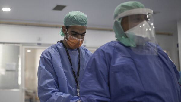 Пандемия коронавируса COVID 19 - врачи одевают защитные костюмы в больнице - Sputnik Грузия