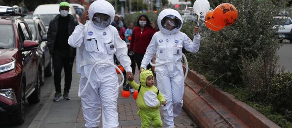 Пандемия коронавируса COVID 19 - родители в защитных костюмах в образе космонавтов ведут ребенка, Боливия - Sputnik Грузия