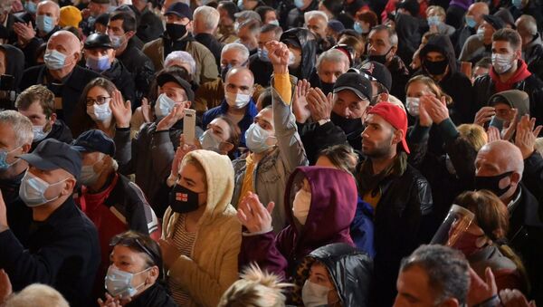 Поднятые руки. Люди в масках от коронавируса. Акция протеста оппозиции у здания парламента Грузии 9 ноября 2020 года - Sputnik Грузия
