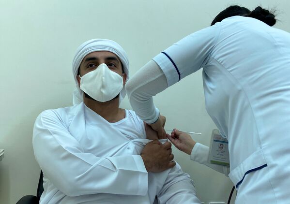 Мужчина получает дозу вакцины против COVID-19 в Дубае - Sputnik Грузия