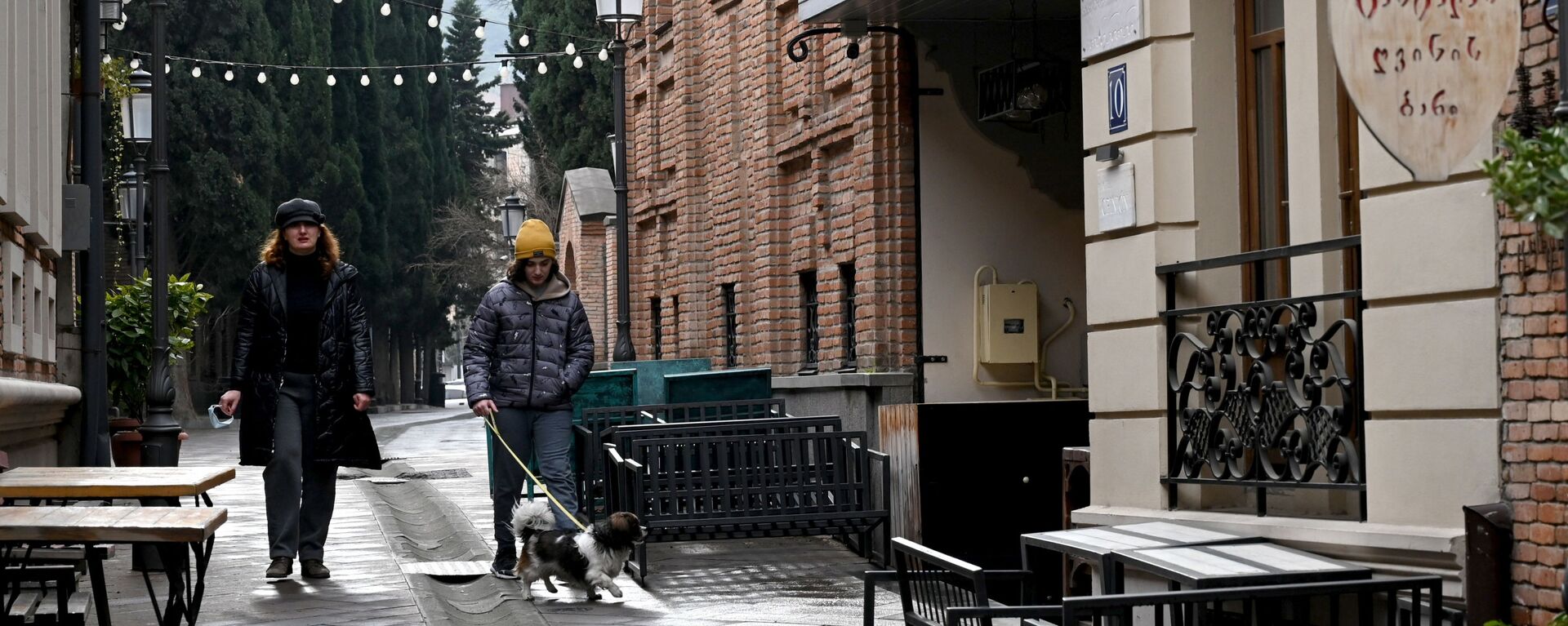 Виды Тбилиси - прохожие на улице в старом городе идут мимо закрытых кафе - Sputnik საქართველო, 1920, 25.03.2021