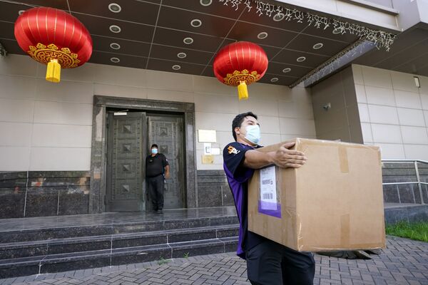 Сотрудник FedEx забирает ящик из китайского консульства в Хьюстоне - Sputnik Грузия