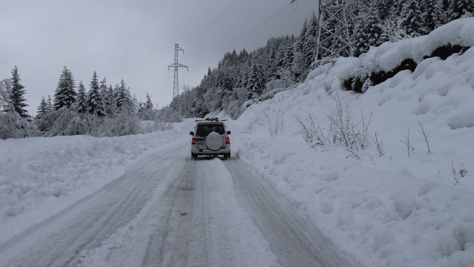 Горная дорога в снегу - машина едет среди снежных сугробов - Sputnik Грузия, 1920, 28.11.2021