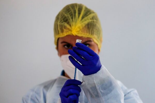 Медицинский работник готовит дозу вакцины Pfizer-BioNTech во время массовой вакцинации в Испания - Sputnik Грузия