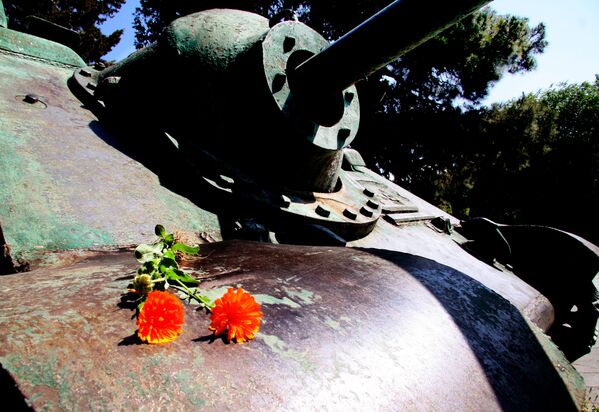 Цветы на танках не растут. Но кто-то заботливо положил их на старую броню у входа на тбилисское военное кладбище времен войны - Sputnik Грузия