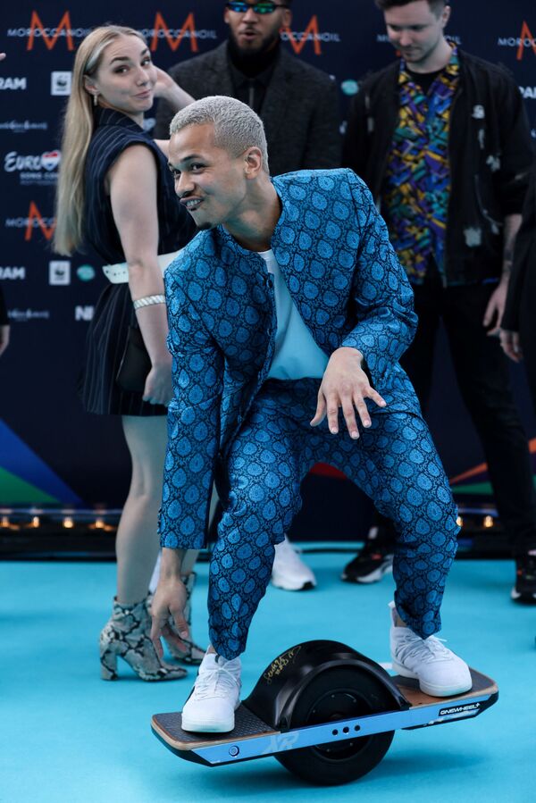 Певец Бенни Кристо на бирюзовой ковровой дорожке перед началом церемонии открытия Евровидения-2021 в Роттердаме - Sputnik Грузия