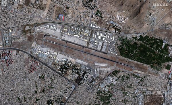 Один подрыв совершил террорист-смертник, затем взорвался заминированный автомобиль. На фото - вид с воздуха на аэропорт Кабула - Sputnik Грузия