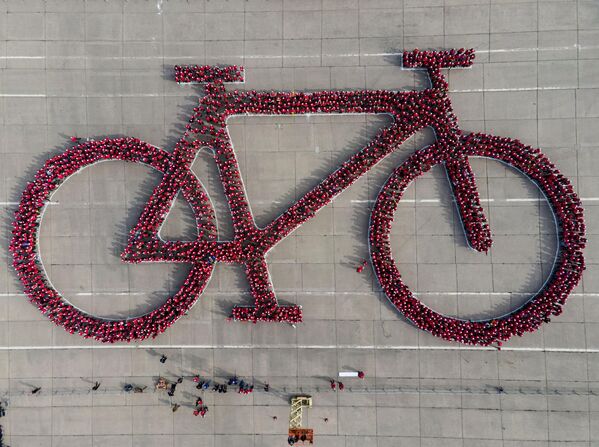 Тысячи людей собираются вместе, чтобы создать самое большое изображение велосипеда в попытке побить мировой рекорд Гиннесса, в парке О&#x27;Хиггинс в Сантьяго, Чили. - Sputnik Грузия