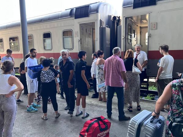 По дороге садятся новые пассажиры, а прежние выходят на перрон, так как внутри поезда днем жарко, кондиционирование там отключено. - Sputnik Грузия