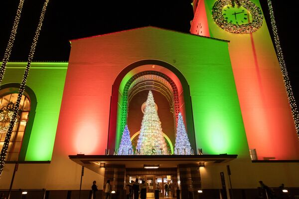 Станция Union Station в Лос-Анджелесе освещена красным и зеленым светом во время церемонии зажжения рождественской елки. - Sputnik Грузия