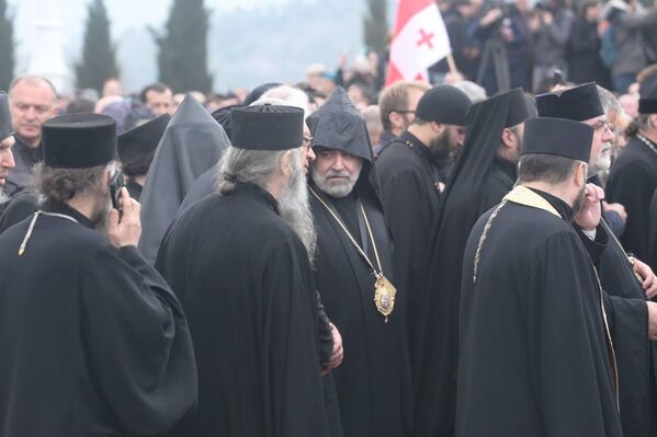 Священнослужители идут позади процессии, сопровождая Патриарха в последний путь. - Sputnik Грузия