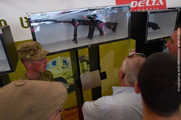 На фото - посетители выставки рассматривают автоматическую винтовку калибра 5,56, производимую в Грузии (магазин на 30 патронов, скорострельность 700-950 выстрелов в минуту, прицельная дальность стрельбы 500-600м). - Sputnik Грузия