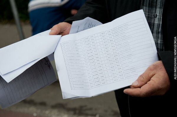 Водители автобусов показывают листы, где выписаны штрафы за неправильную парковку. - Sputnik Грузия