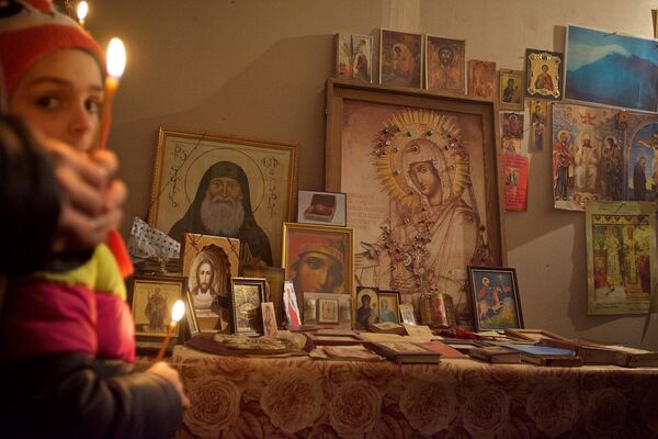 Девочка молится у мироточащих икон в квартире семьи Какошвили. - Sputnik Грузия