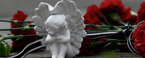 Цветы и фигурка ангела в память о погибших - Sputnik Грузия