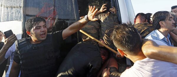 Полицейский сдерживает возмущенную толпу на мосту через Босфор, во время сдачи мятежных военных - Sputnik Грузия