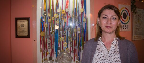 Нино Салуквадзе рядом со своими наградами, заслуженными на международных соревнованиях по стрельбе - Sputnik Грузия