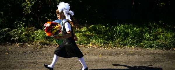 Девочка идёт в школу на торжественную линейку, посвященную Дню знаний, в село Новолуговое Новосибирской области - Sputnik Грузия