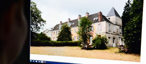 Девушка рассматривает на компьютере фото поместья Левиль во Франции - Sputnik Грузия