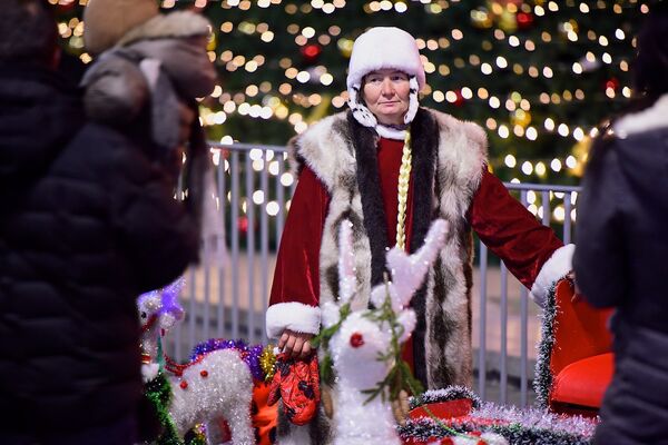 В Грузии как правило, Дед Мороз приходит поздравлять с Новым годом один, без Снегурочки. Однако сейчас у главной новогодней елки страны была замечена подружка Дед-Мороза, которая помогала ему фотографироваться с жителями и гостями Тбилиси - Sputnik Грузия