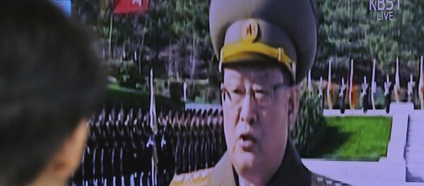 Мужчина смотрит на трансляцию выступления министра госбезопасности Северной Кореи Ким Вон Хона - Sputnik Грузия