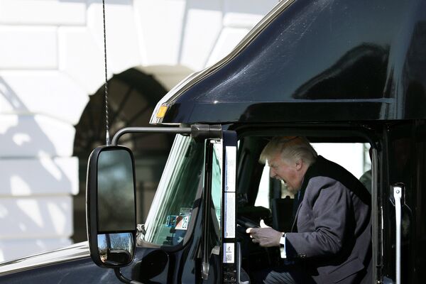 Президент США Дональд Трамп пробует себя в роли водителя грузовика во время встречи с лидерами Американской ассоциации грузоперевозок - Sputnik Грузия