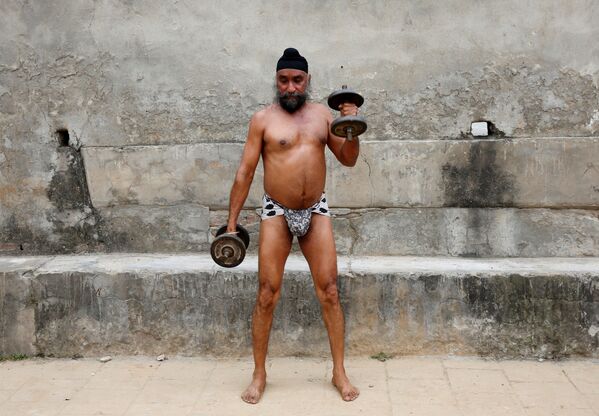 Мужчина с гантелями во время тренировки в традиционном тренировочном центре борьбы под названием Akhaara в Джамму. Этот штат представляет из себя спорную территорию, право на которую предъявляют Индия и Пакистан - Sputnik Грузия