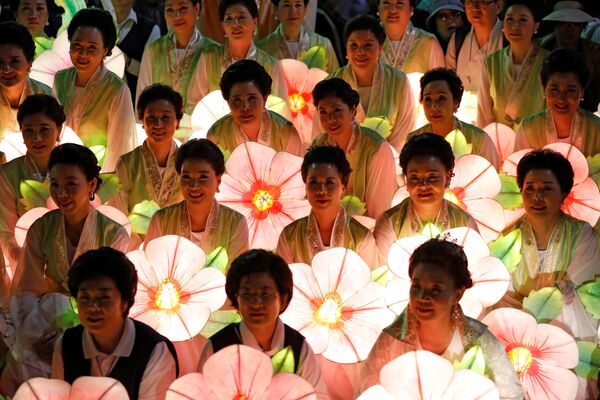 Буддийские верующие с фонариками позируют для группового фото после завершения парада в честь Дня рождения Будды в Сеуле, Южная Корея - Sputnik Грузия