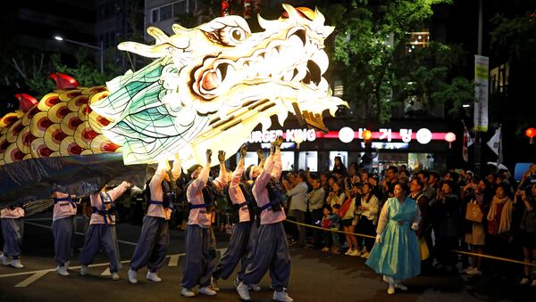 Буддийские верующие с гигантским драконообразным фонарем во время парада в честь наступающего дня рождения Будды в Сеуле, Южная Корея - Sputnik Грузия