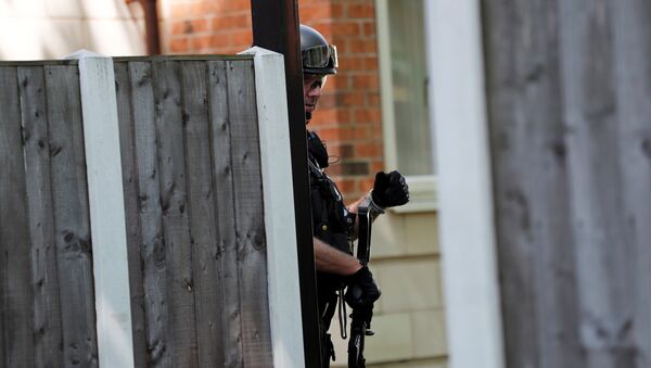 Вооруженный офицер британской полиции в Манчестере, у здания где был арестован подозреваемый мужчина - Sputnik Грузия