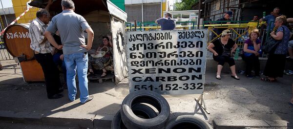 Торговый центр автозапчастей, автомобильных масел и аксессуаров на рынке Элиава после пожара - Sputnik Грузия