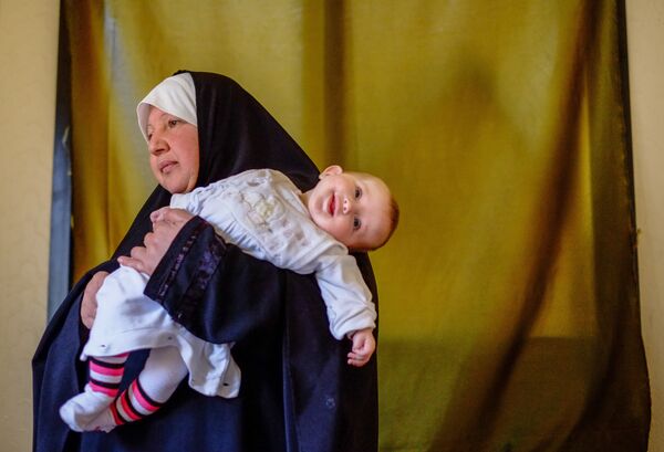 Женщина с ребенком - беженцы из Сирии - в одном из домов в городе Хальба на севере Ливана, 2013 год - Sputnik Грузия
