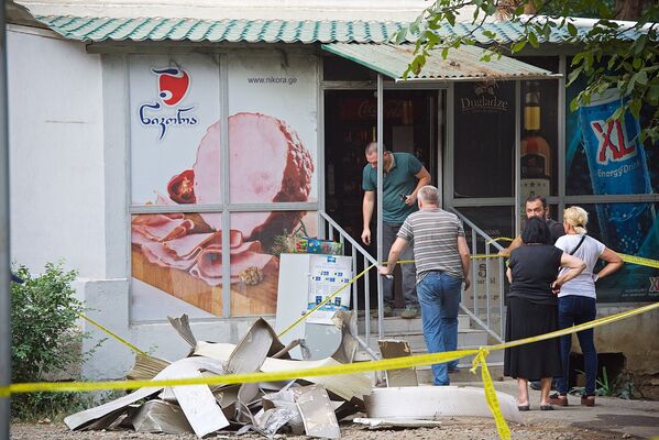 Владельцы и сотрудники частного магазина, в котором в основном продавались продукты питания, спасают имущество после взрыва в соседнем жилом помещении многоквартирного дома - Sputnik Грузия