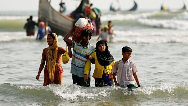 Беженцы из Мьянмы выходят на берег со своими вещами после пересечения границы Бангладеш-Мьянма на лодке через Бенгальский залив - Sputnik Грузия