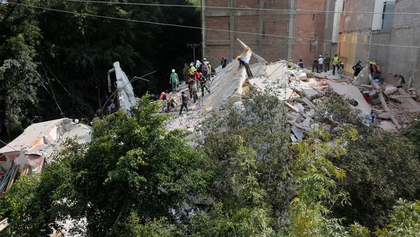 Спасатели работают в поисках выживших на месте разрушенного землетрясением здания в Мехико, Мексика - Sputnik Грузия