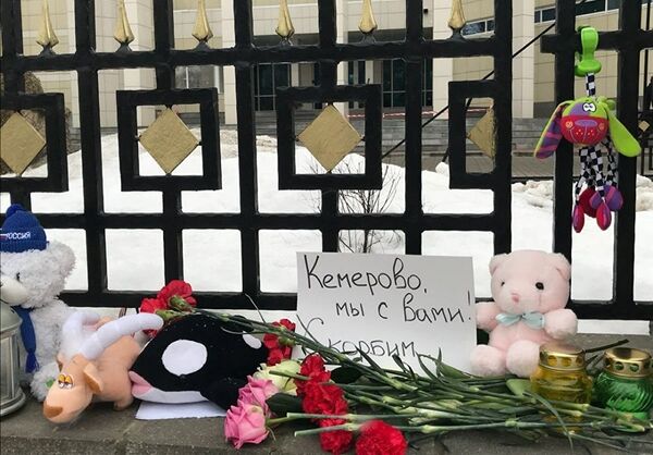 Цветы, свечи и игрушки у посольства России в Беларуси в память о погибших при пожаре в торговом центре в Кемерово - Sputnik Грузия