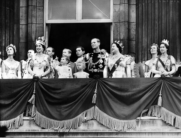 Подготовка к коронации Елизаветы II началась, как только она вступила на престол в феврале 1952 года. Но лишь 16 месяцев спустя состоялось торжество. На фото - Королева Елизавета II в сопровождении принца Филиппа, герцога Эдинбургского, принца Чарльза, принцессы Анны, королевы-матери Елизаветы и принцессы Маргарет появляется на балконе Букингемского дворца в день коронации - Sputnik Грузия