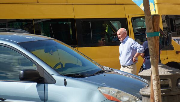 Желтые маршрутные такси у автобусной остановки, где люди ждут транспорт - Sputnik Грузия