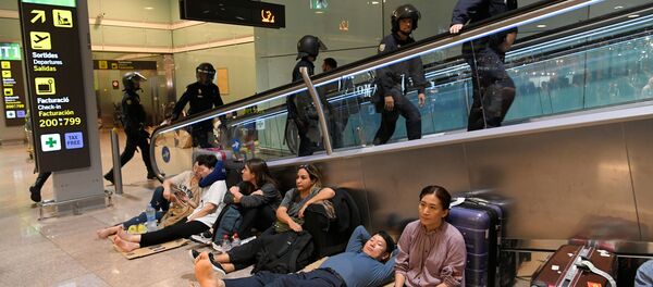 Испанские полицейские и пассажиры в аэропорту Барселоны, работа которого была парализована протестующими за независимость Каталонии - Sputnik Грузия