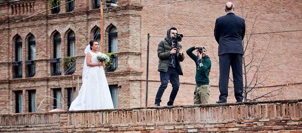 Свадьба в старом районе города. Молодожены принимают участие в фотосессии - Sputnik Грузия
