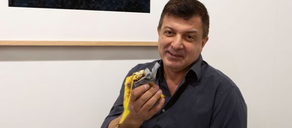 Нью-йоркский художник грузинского происхождения Дэвид Датуна ест банан из художественной инсталляции - Sputnik Грузия