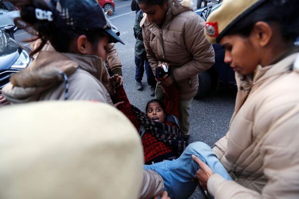 В Столице Индии конец года сопровождается беспорядками. На фото полиция задерживает демонстрантку акции протеста против новых поправок к закону о гражданстве  - Sputnik Грузия