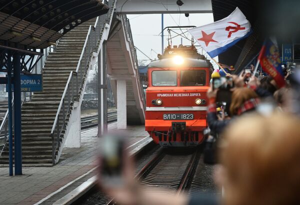 Люди собираются на железнодорожной станции во время прибытия поезда Таврия после открытия автомобильного и железнодорожного моста через Керченский пролив в Севастополе - Sputnik Грузия