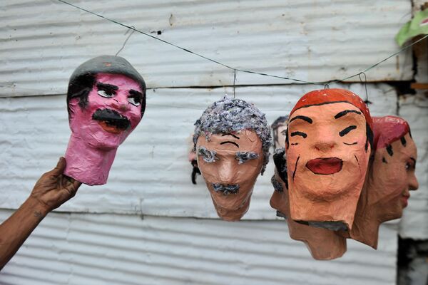 Накануне Нового года на улицах Колумбии проходит традиционное шествие самодельных кукол, изображающих старый год. Это десятки разнообразных кукольных клоунов, ведьм и других сказочных персонажей, которые крепятся к крышам машин, проезжают по улицам Канделарии – самого древнего района колумбийской столицы, прощаясь с жителями города - Sputnik Грузия