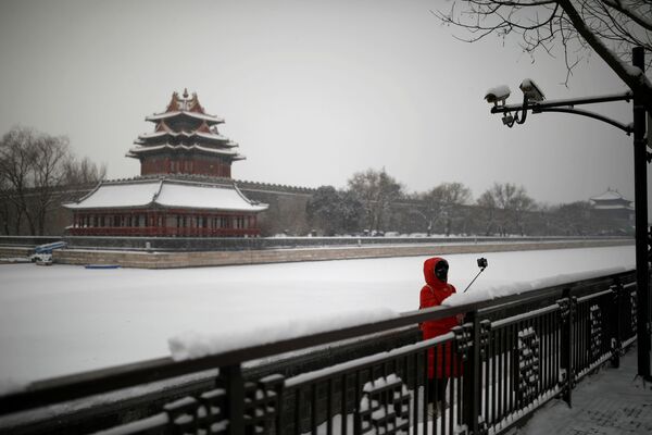 Туристов и местных жителей на улицах почти нет. Девушка в маске во время селфи у Запретного города в Пекине  - Sputnik Грузия