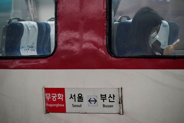 Грустная картина. Девушка в маске едет в метро в Сеуле, Южная Корея, опасаясь коронавируса. В этой стране зафиксировано уже около 1000 случаев заболевания - Sputnik Грузия