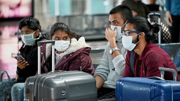 Туристы в масках в зале ожидания в тбилисском аэропорту во время превентивных мер против коронавируса - Sputnik Грузия