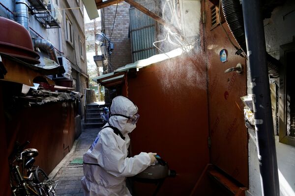 Сотрудник компании, оказывающей услуги по санитарной обработке, дезинфецирует лачугу в трущобах в Сеуле, Южная Корея, после вспышки коронавируса COVID-19  - Sputnik Грузия